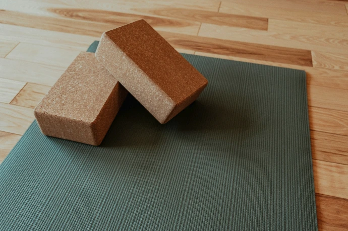 a yoga mat with two blocks on top of it