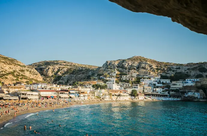 a beach with people and buildings