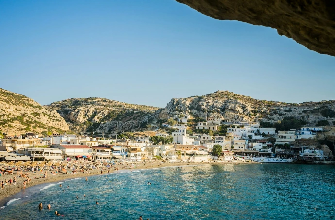 a beach with people and buildings